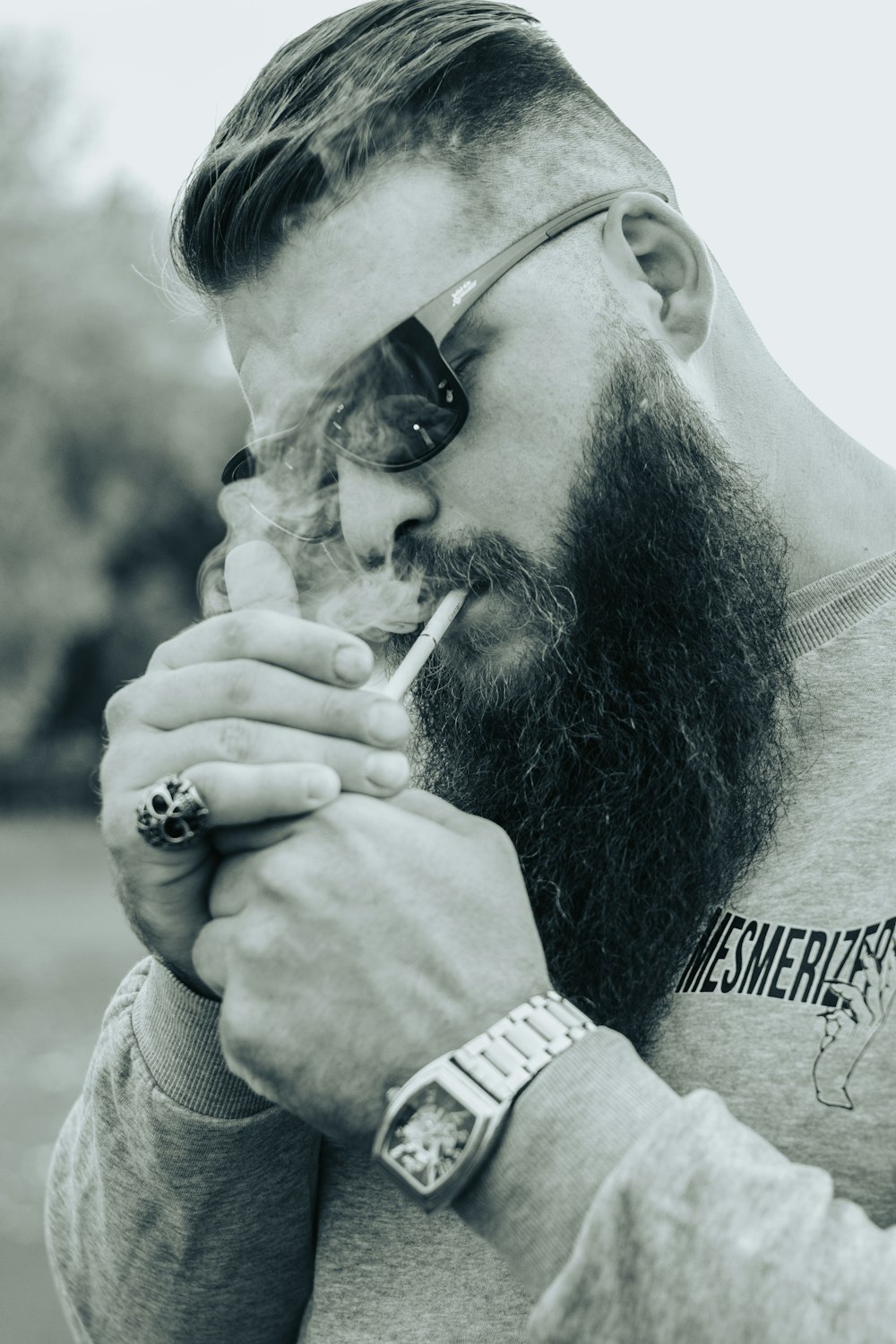 a man with a long beard smoking a cigarette
