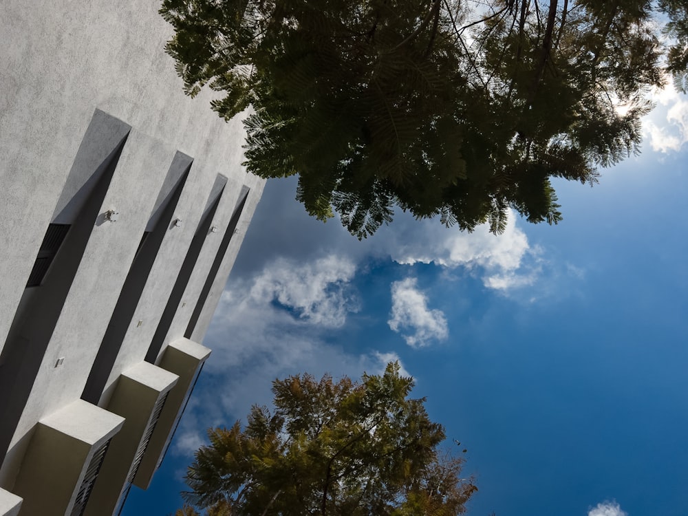 looking up at a tall building with a sky in the background