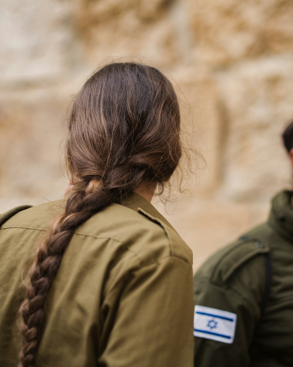 a woman with a long braid standing next to a man