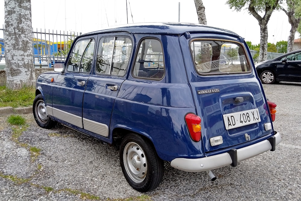 a small blue car parked in a parking lot