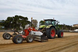 a tractor is parked on a dirt road