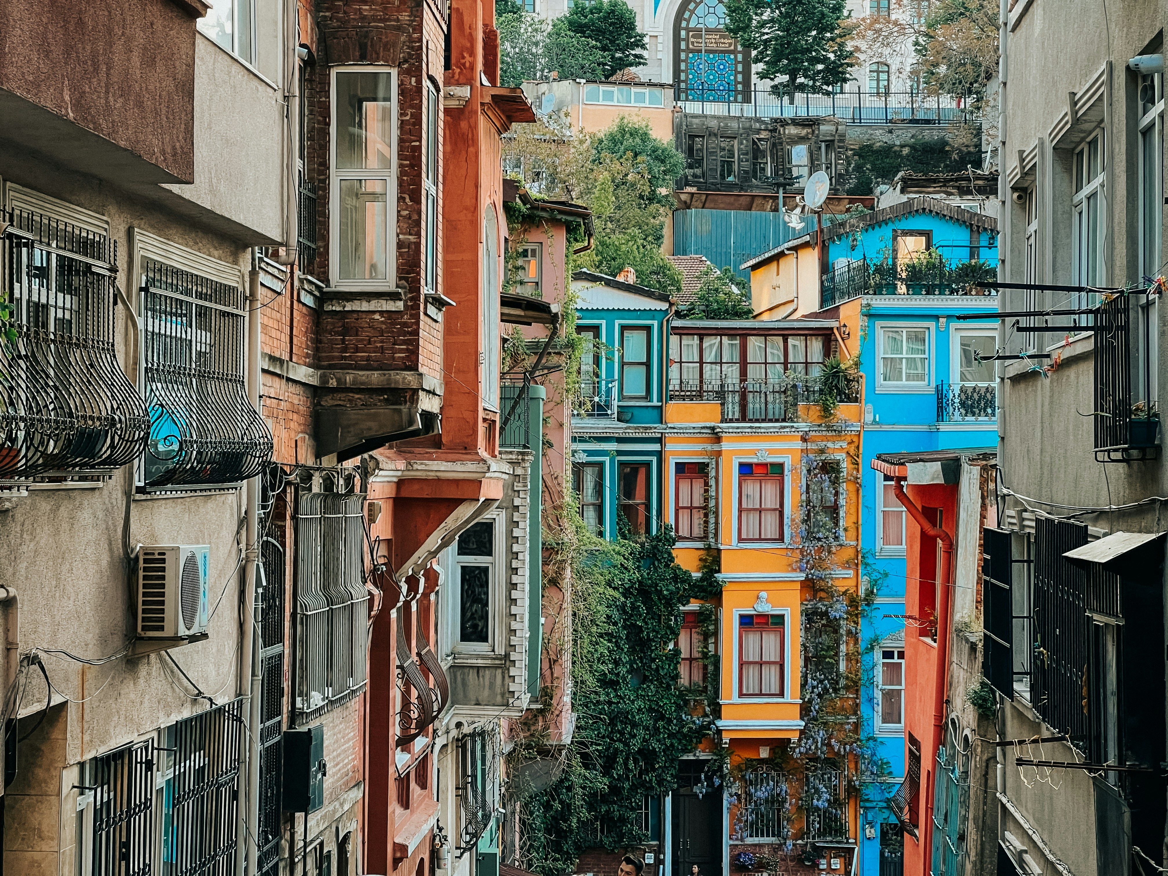 a narrow city street with lots of colorful buildings