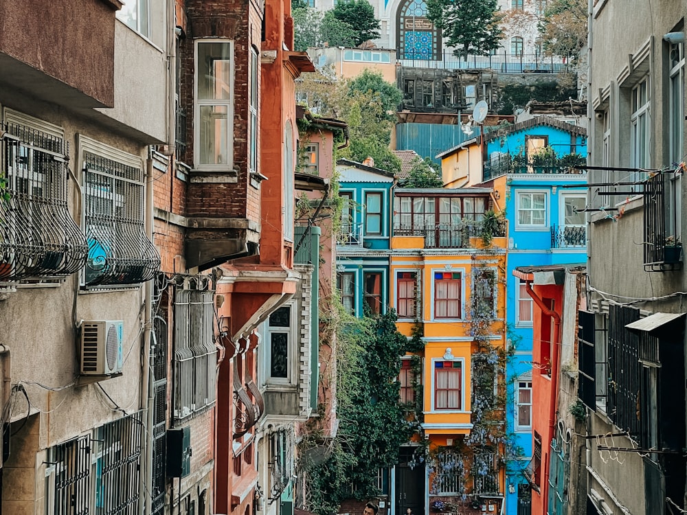 a narrow city street with lots of colorful buildings