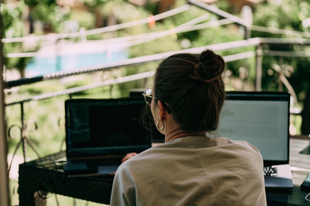 a woman sitting at a table with a laptop