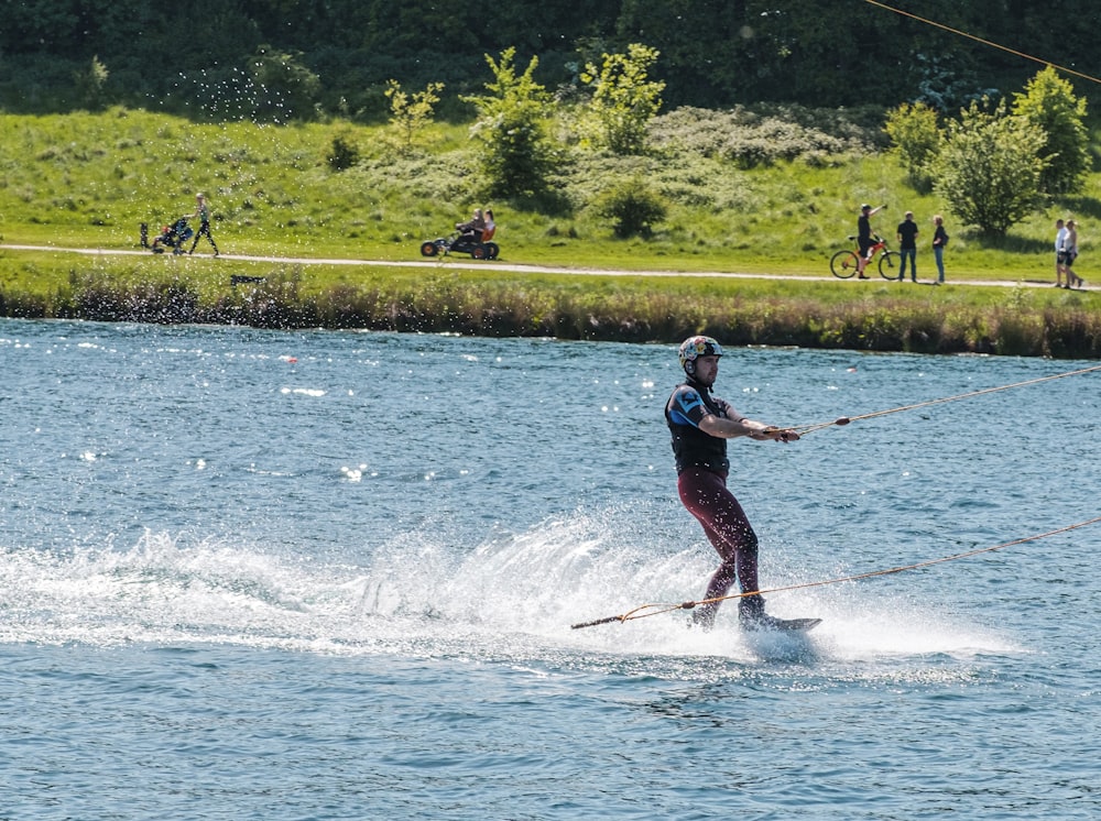 a man riding skis on top of a body of water