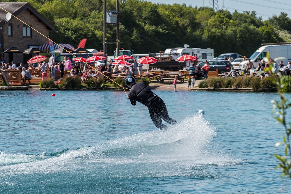 a man riding a wake board on top of a body of water