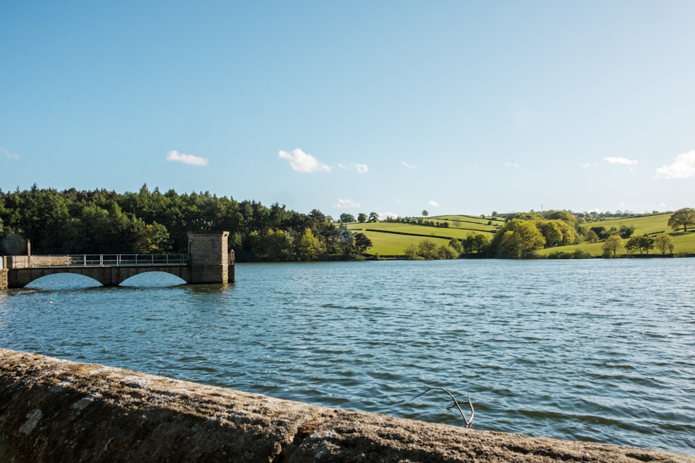 a large body of water with a bridge over it