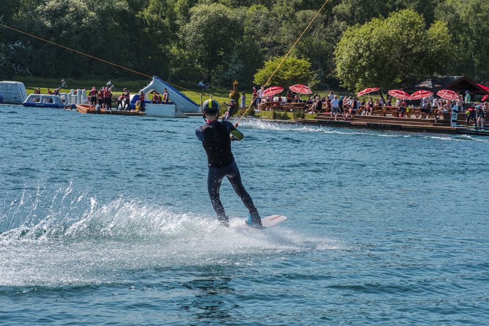 a man riding a board on top of a body of water