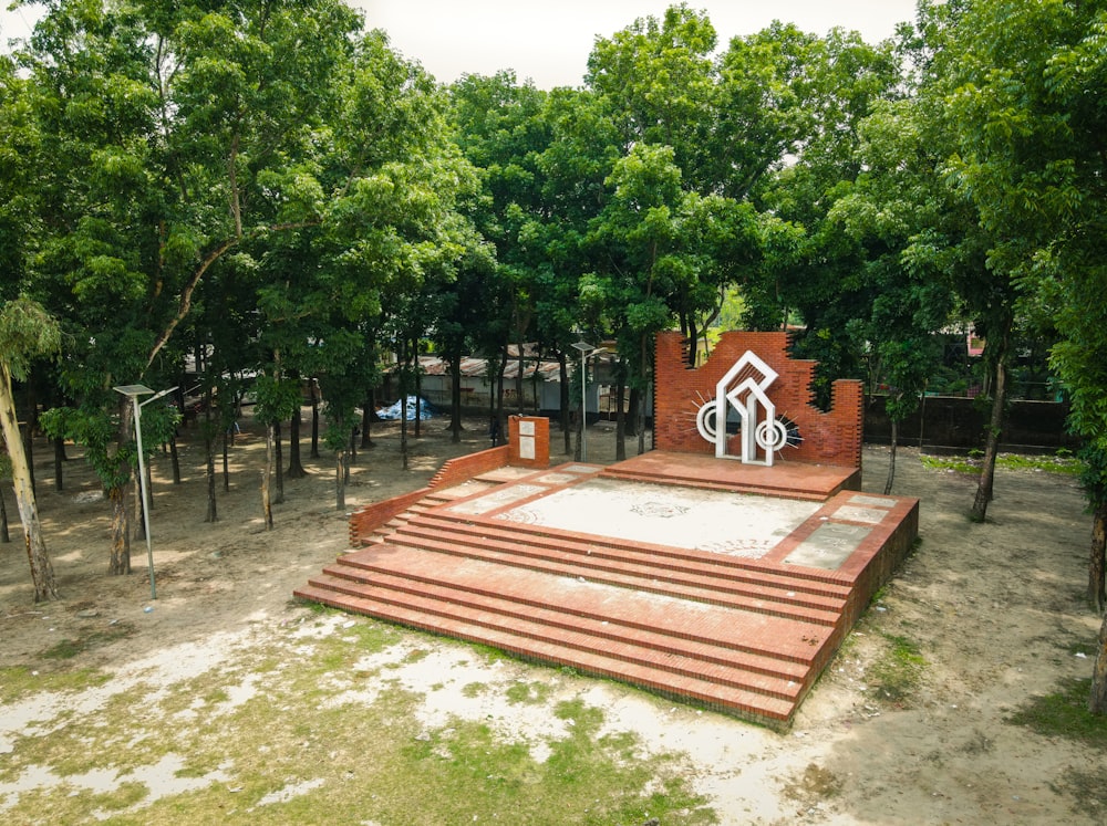 a monument in a park surrounded by trees