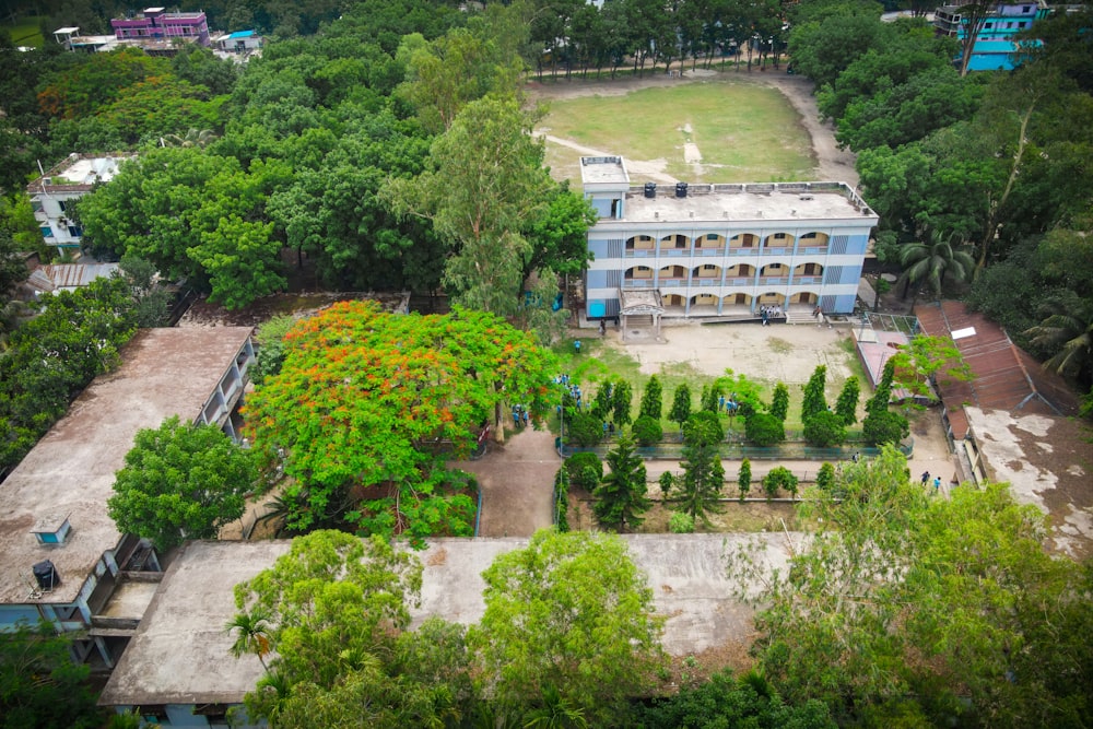 an aerial view of a building surrounded by trees