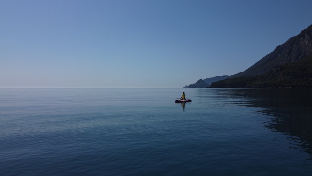 a person in a small boat on a body of water