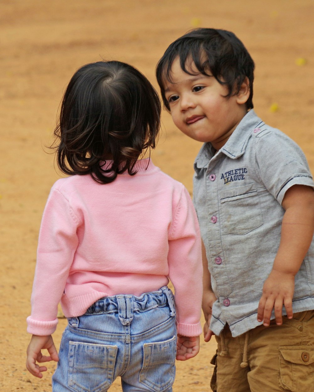 a couple of small children standing next to each other