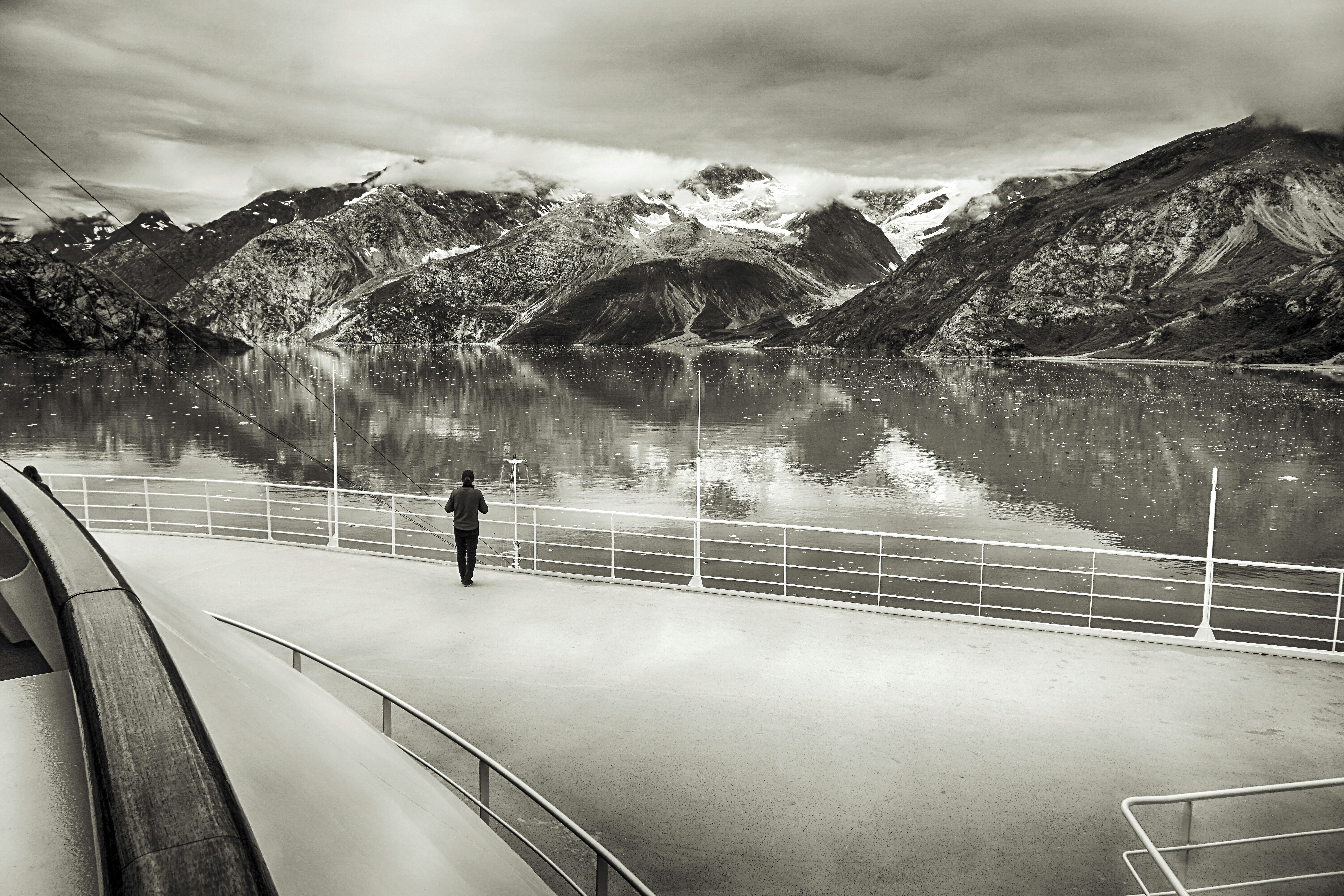 a black and white photo of a person on a boat, 