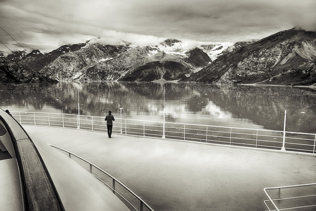 a black and white photo of a person on a boat,