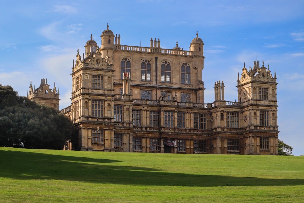 a large building sitting on top of a lush green field