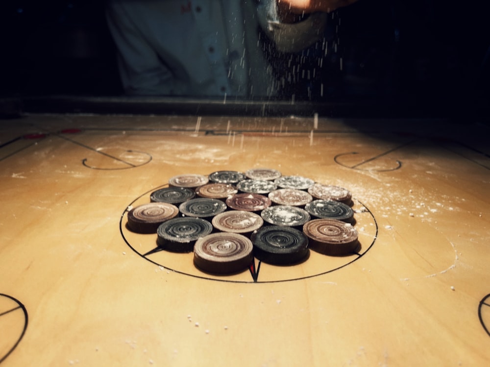 a group of buttons sitting on top of a wooden table