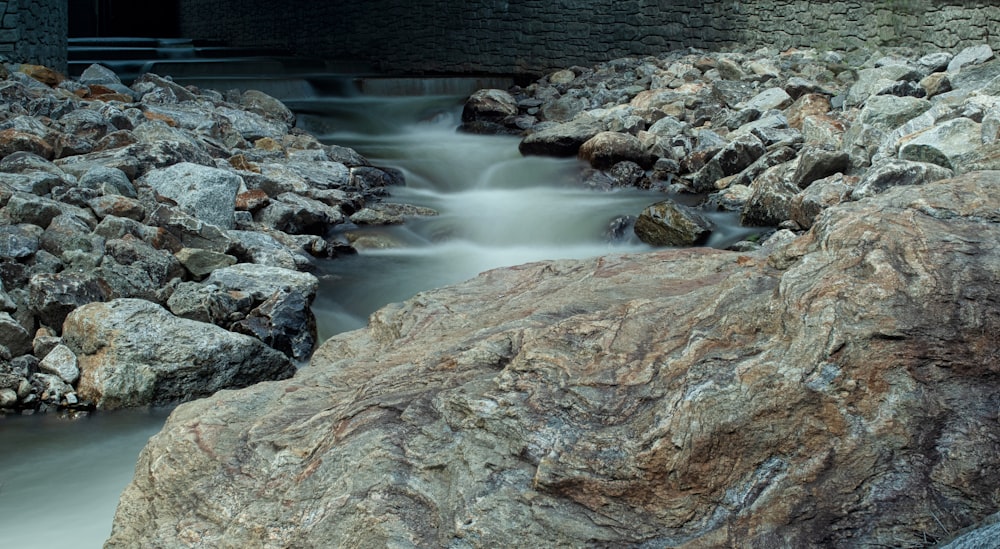 a stream of water running between two large rocks