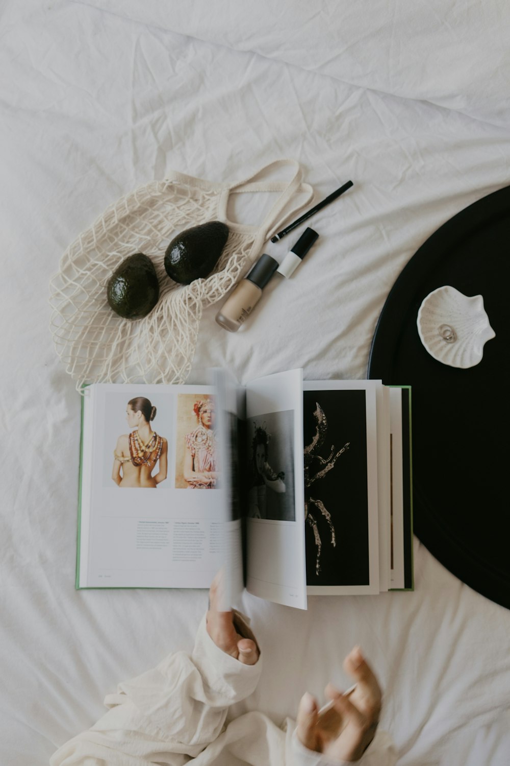 a person laying on a bed reading a book