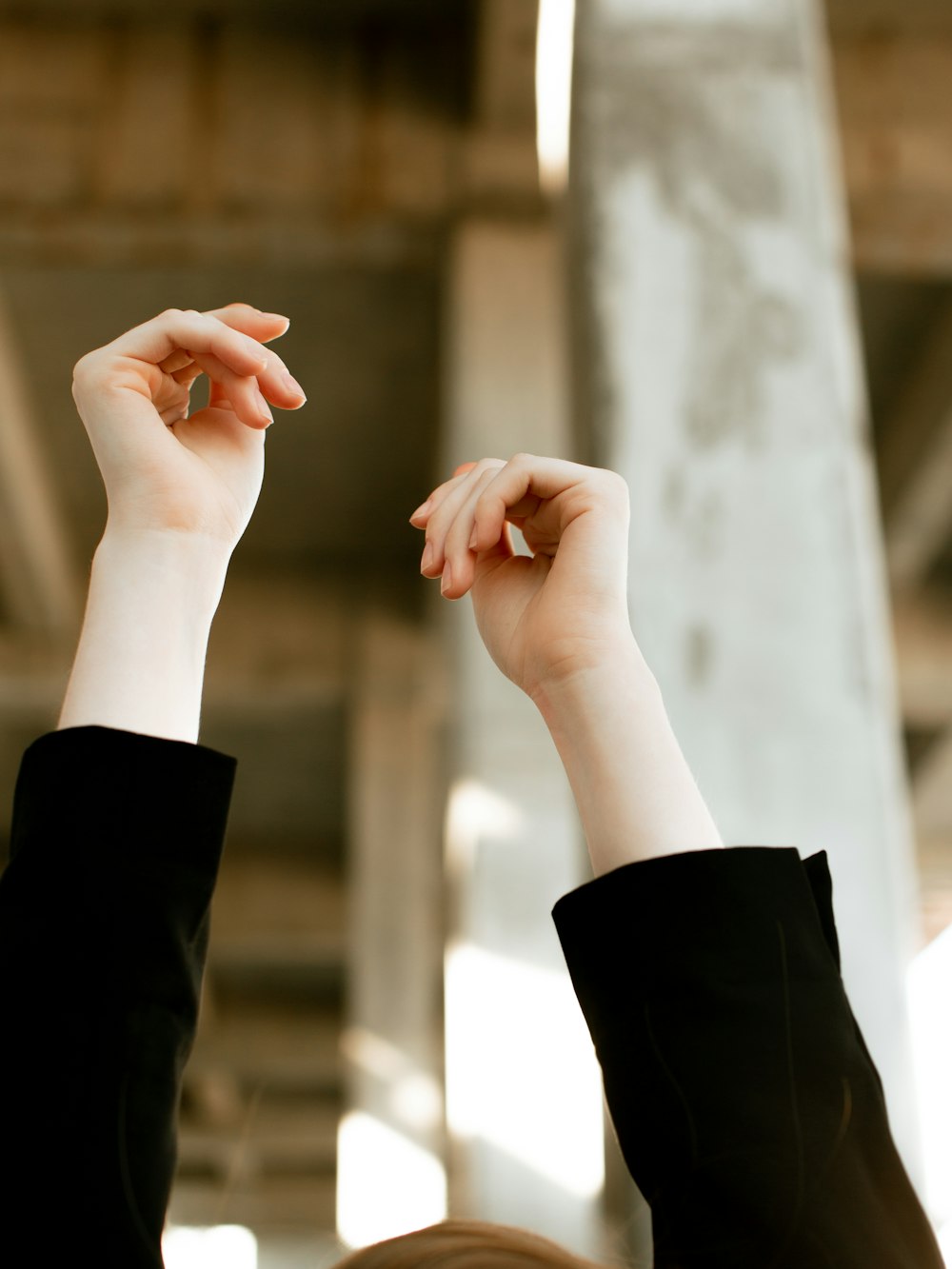 a woman raising her hands in the air