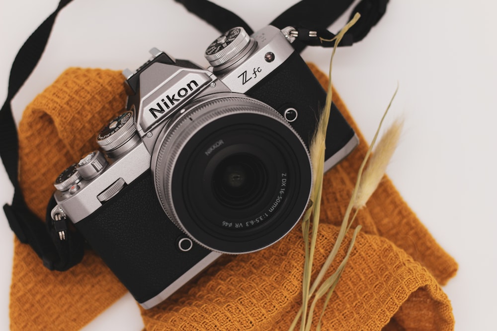 a camera sitting on top of a yellow cloth