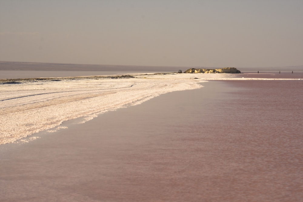 a beach that has some water and sand on it