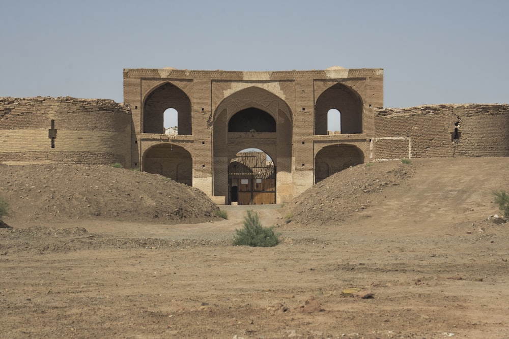 a large brick building with arches and a doorway