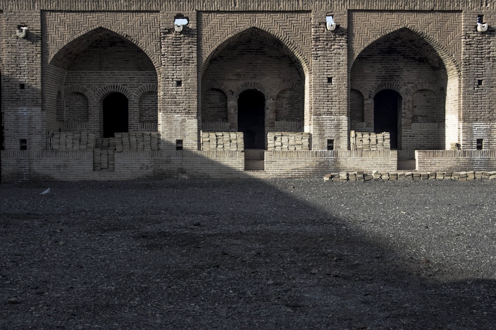 a large brick building with arches and windows