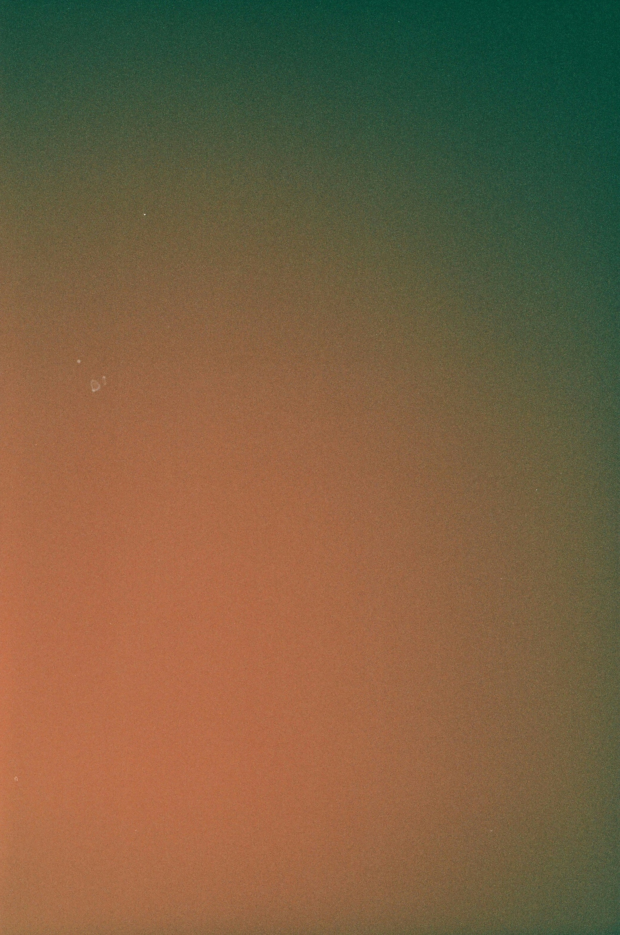 an orange and green background with a plane in the sky