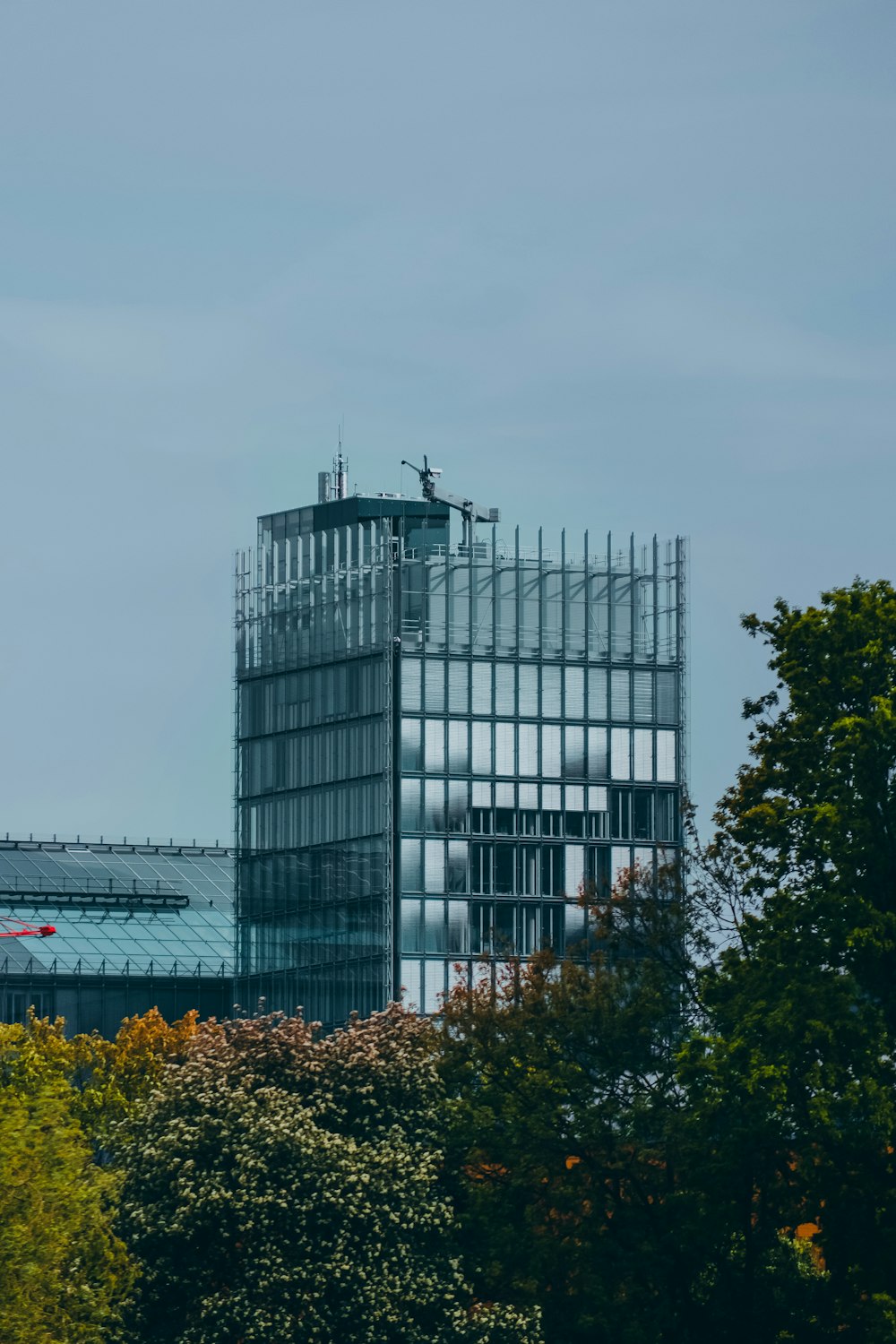 a tall glass building with a sky background