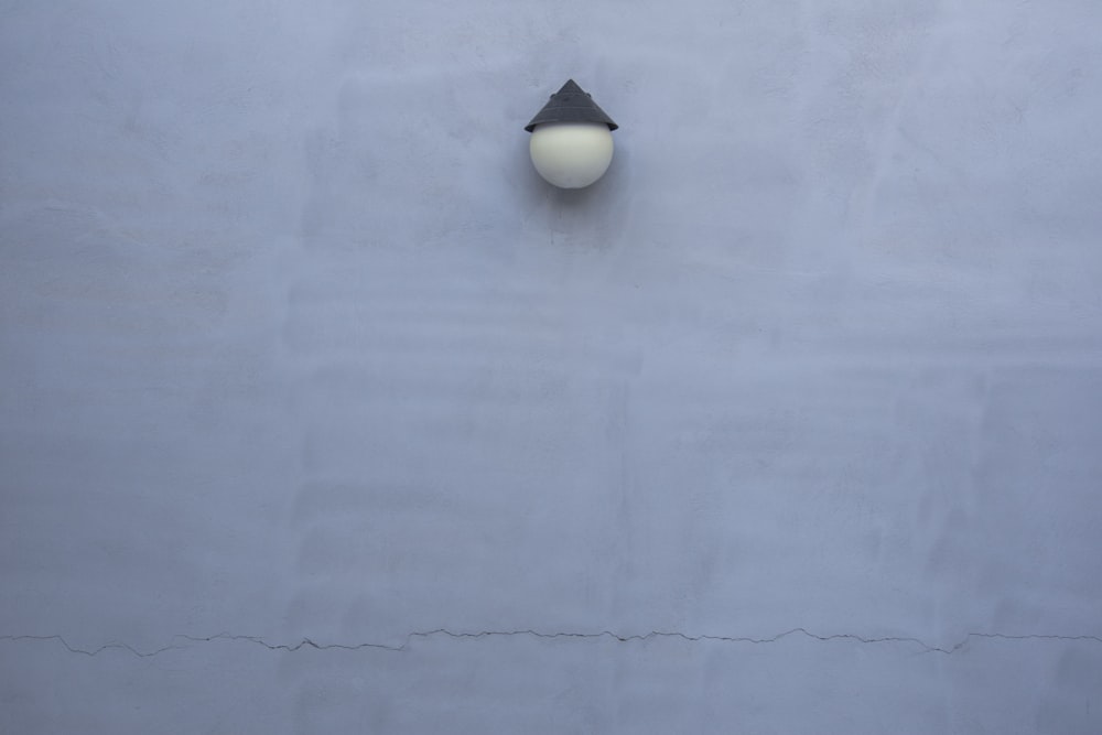 a white wall with a light on it