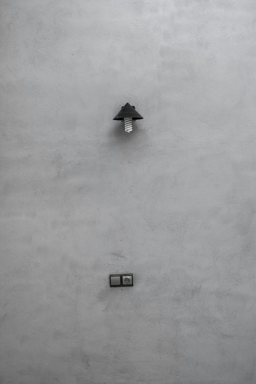 a black and white photo of a clock on a wall