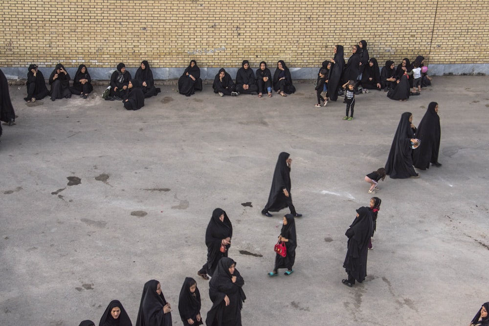 a group of women in black robes standing in a circle