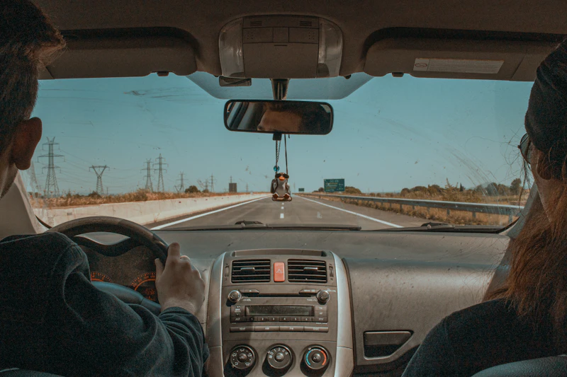 A driver and passenger on a highway