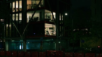 The exterior of our modern office building lit up at dusk, welcoming visitors.