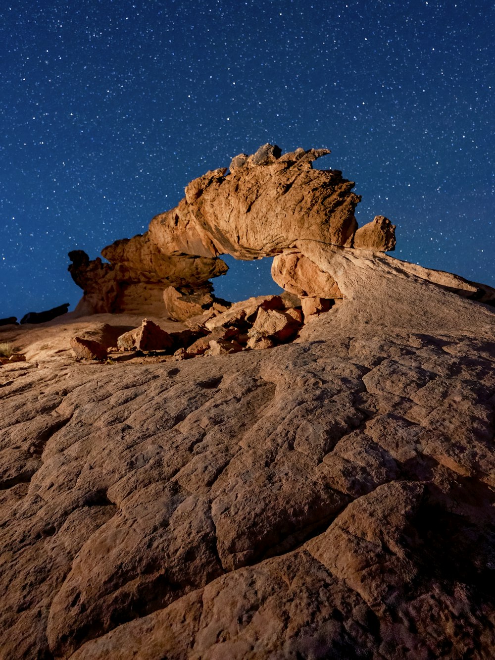 a rock formation with a star filled sky in the background