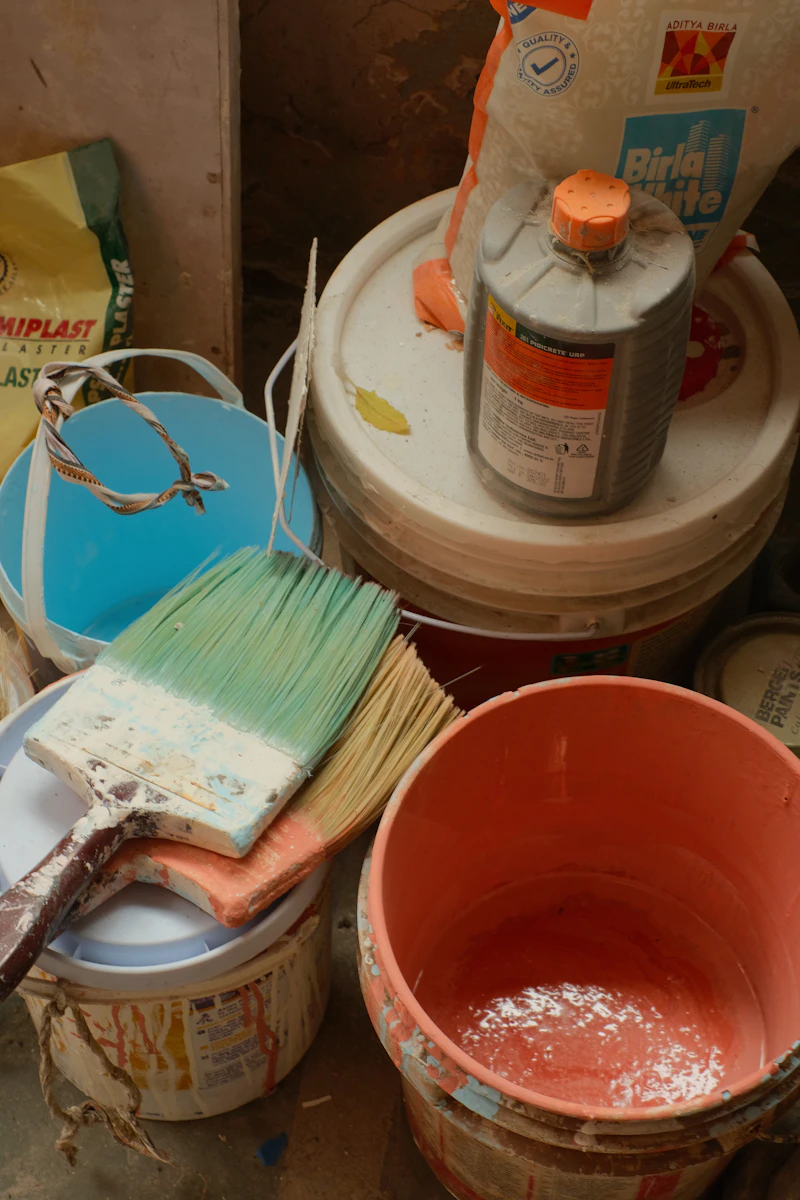 Paint cans and brushes ready for a wall repair job