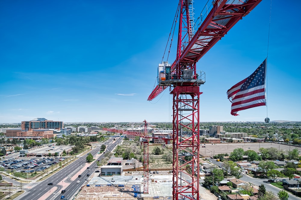 a large crane with a flag on top of it