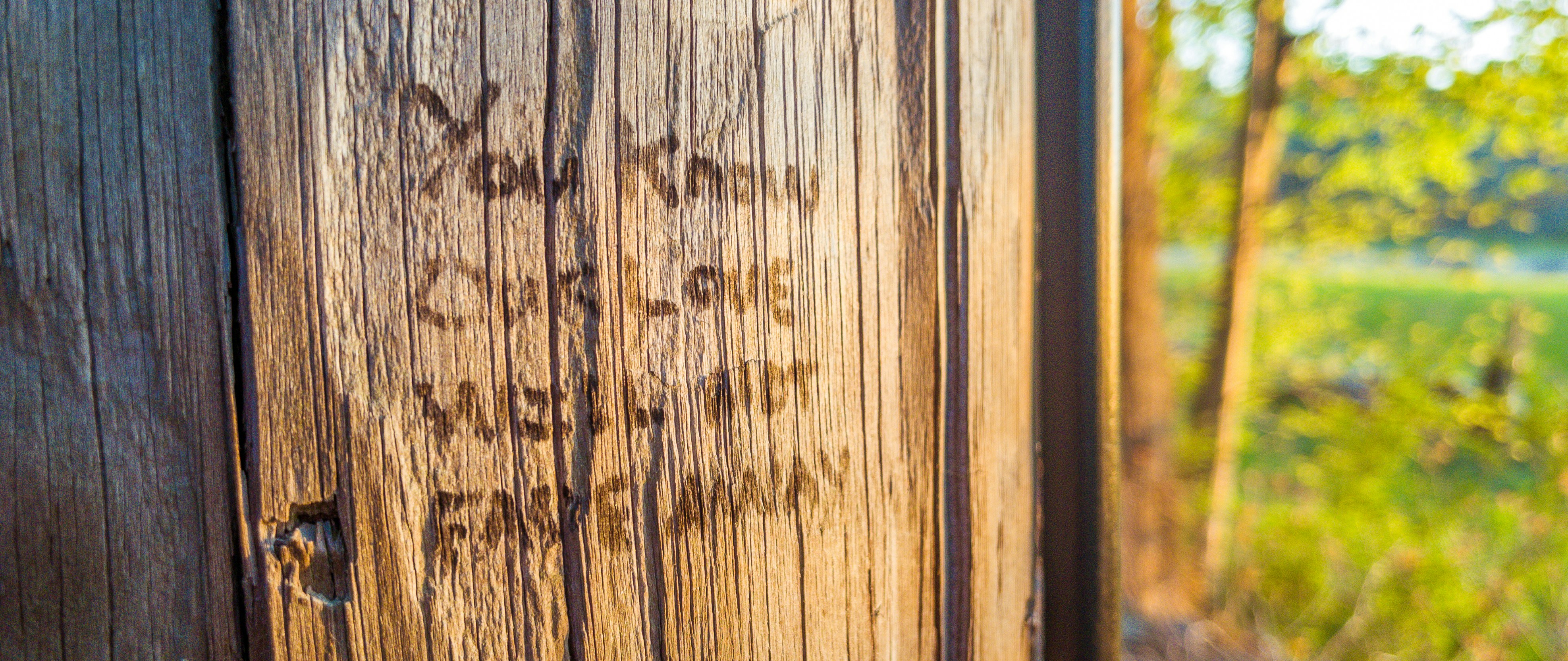 a close up of a wooden door with writing on it