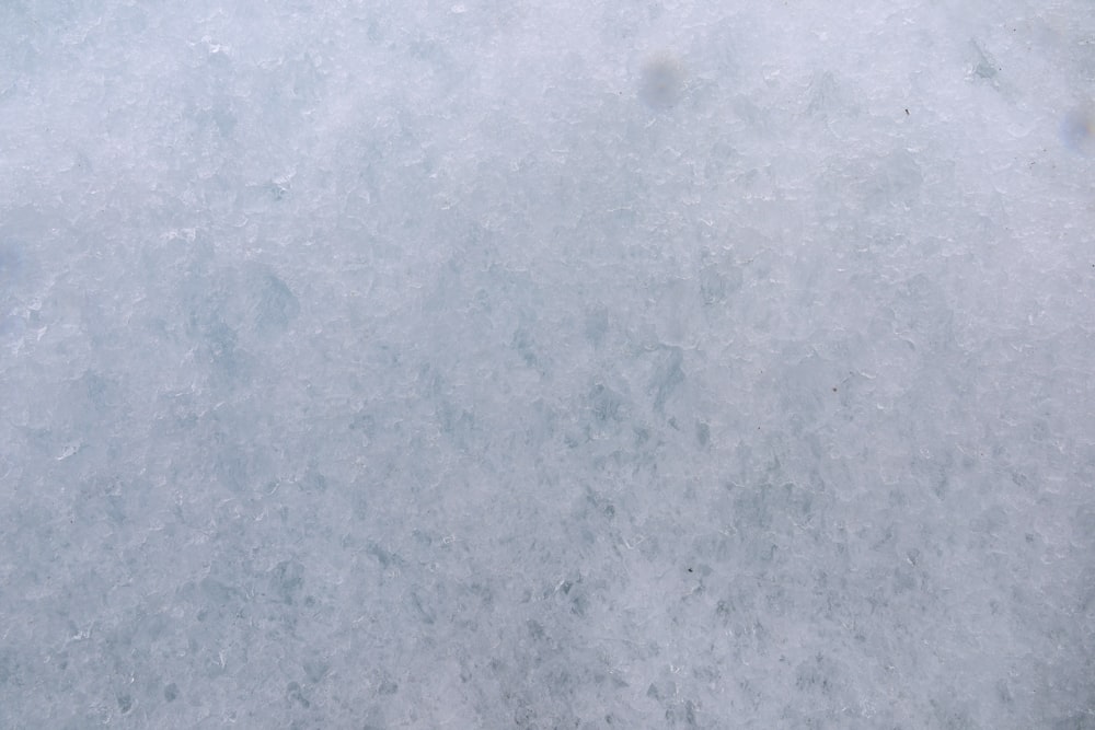 a snowboarder is standing in the snow with his board