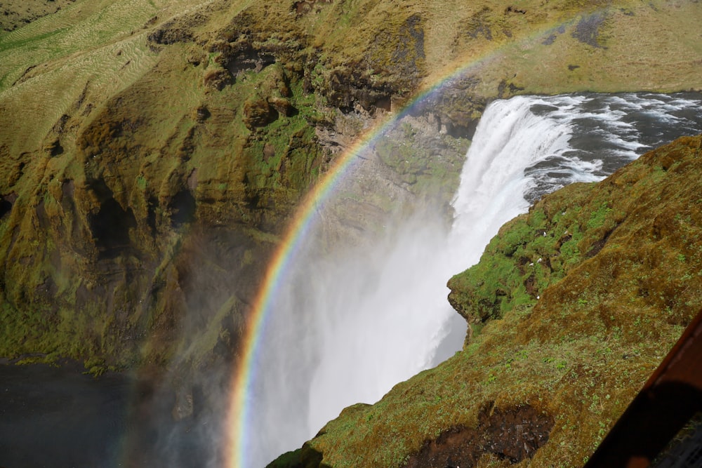 a waterfall with a rainbow in the middle of it