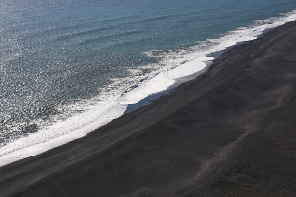 an aerial view of a black sand beach