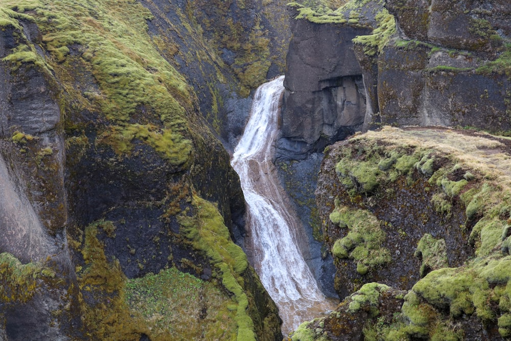 a waterfall in the middle of a rocky area