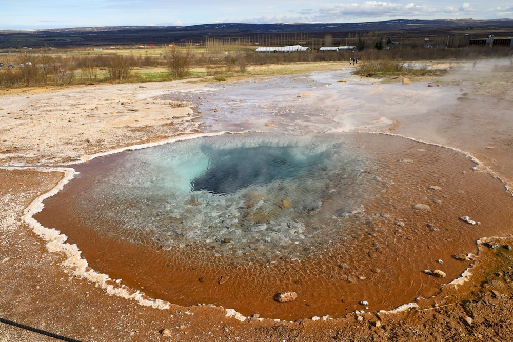a hot spring in the middle of a field