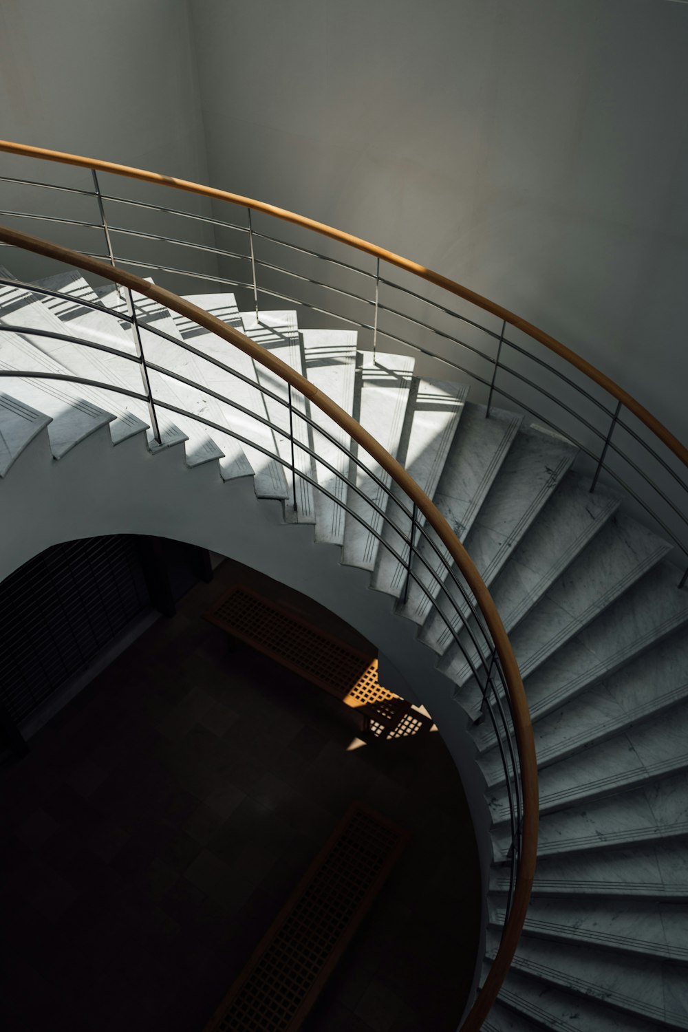 a spiral staircase with a wooden hand rail