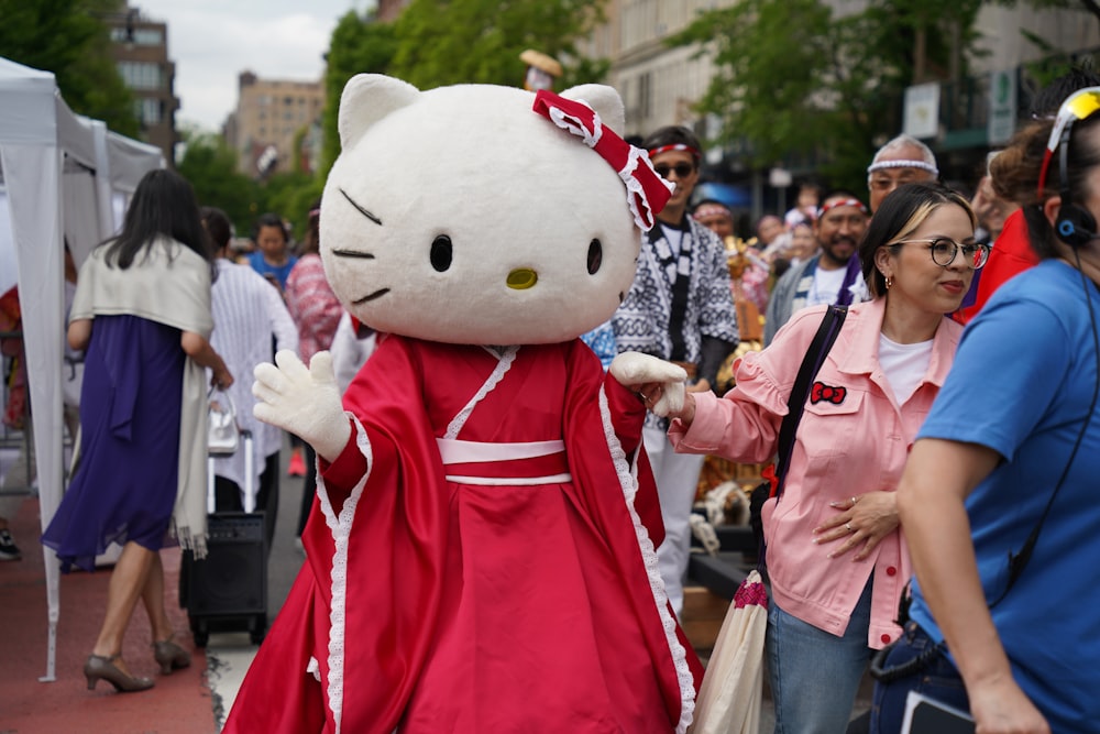 a person in a hello kitty costume walking down a street