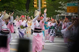 A lively street parade featuring the shinwa eisa group with drums and dancers.