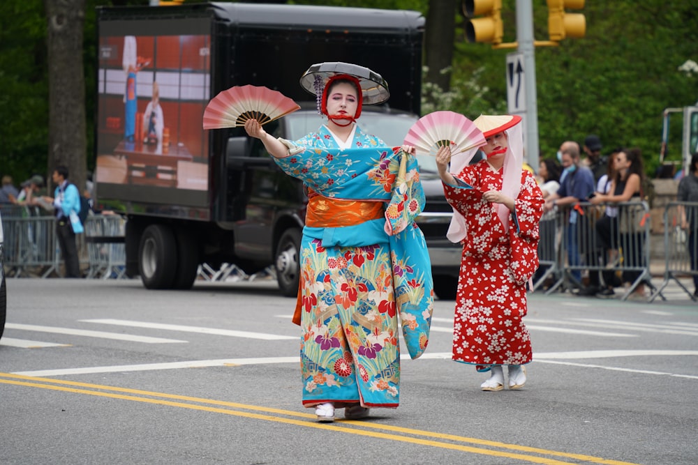 a couple of women that are standing in the street