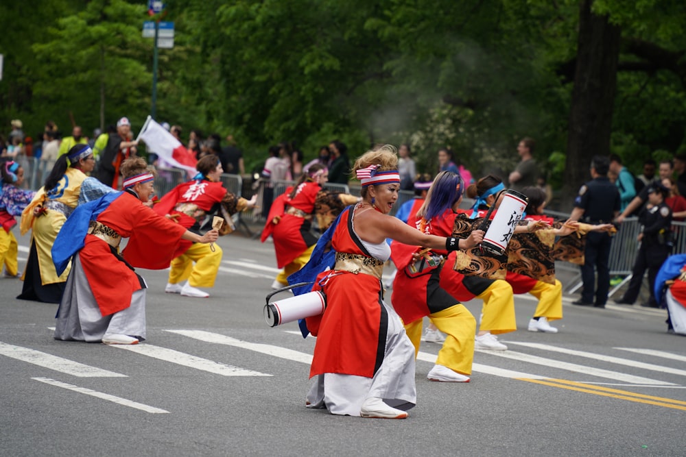 a group of women in costume dancing in the street