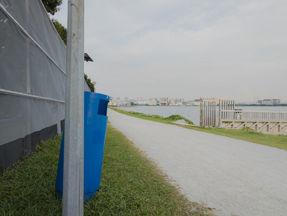 a blue sign sitting on the side of a road