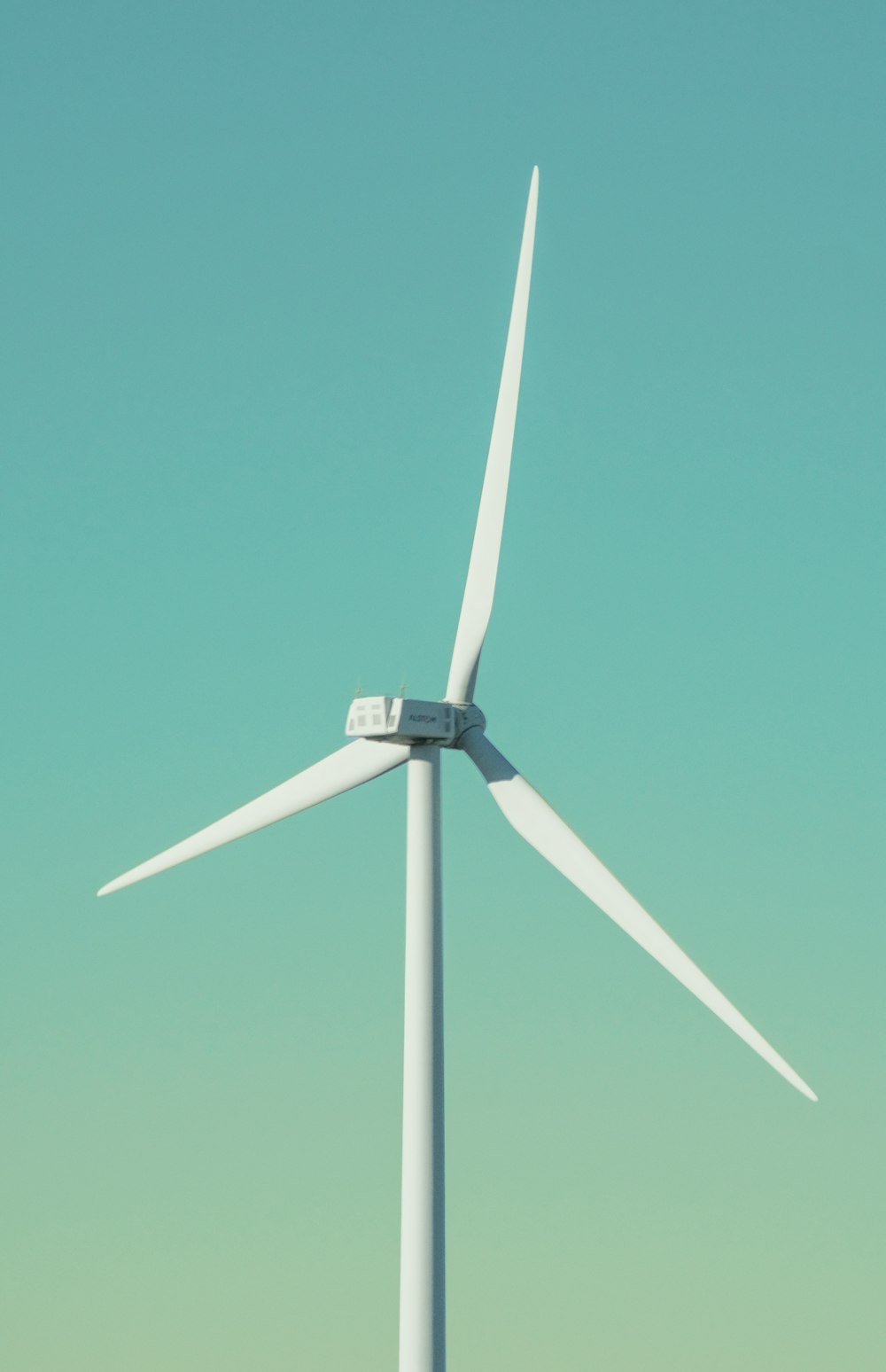 a wind turbine is shown against a blue sky